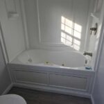 11 master bathroom featuring jacuzzi